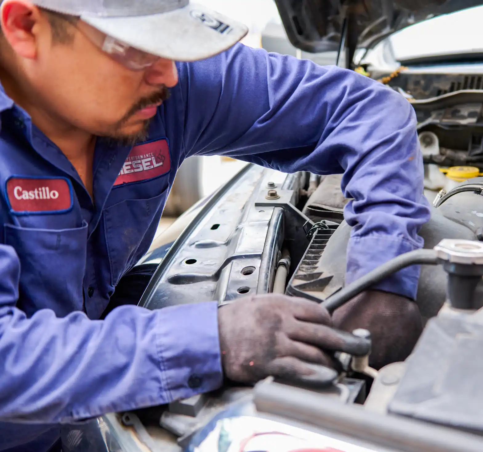 Heavy-duty mechanic performing truck repair at Houston Performance Diesel